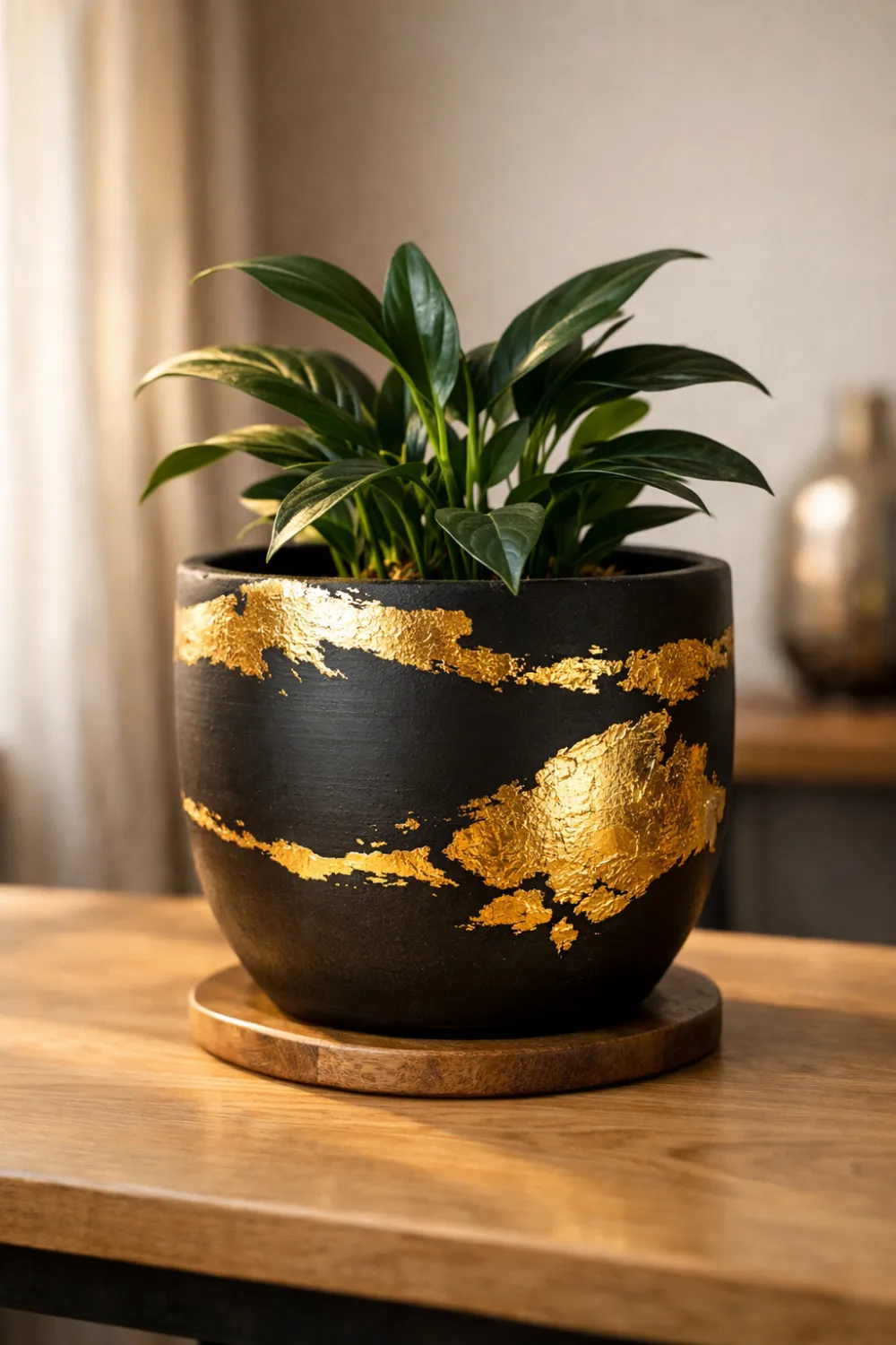 DIY gold leaf planter idea turning simple plant pot into luxury gold accent planter modern indoor plant decor inspiration