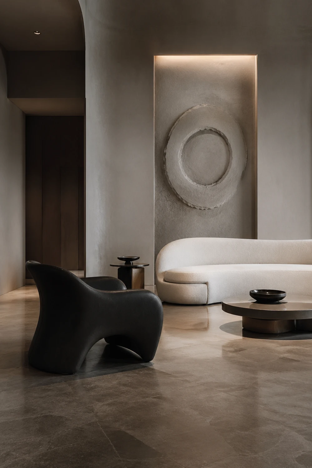 sculptural living room with curved sofa, artistic black lounge chair, textured wall art, neutral tones, minimalist luxury interior, modern gallery style living room