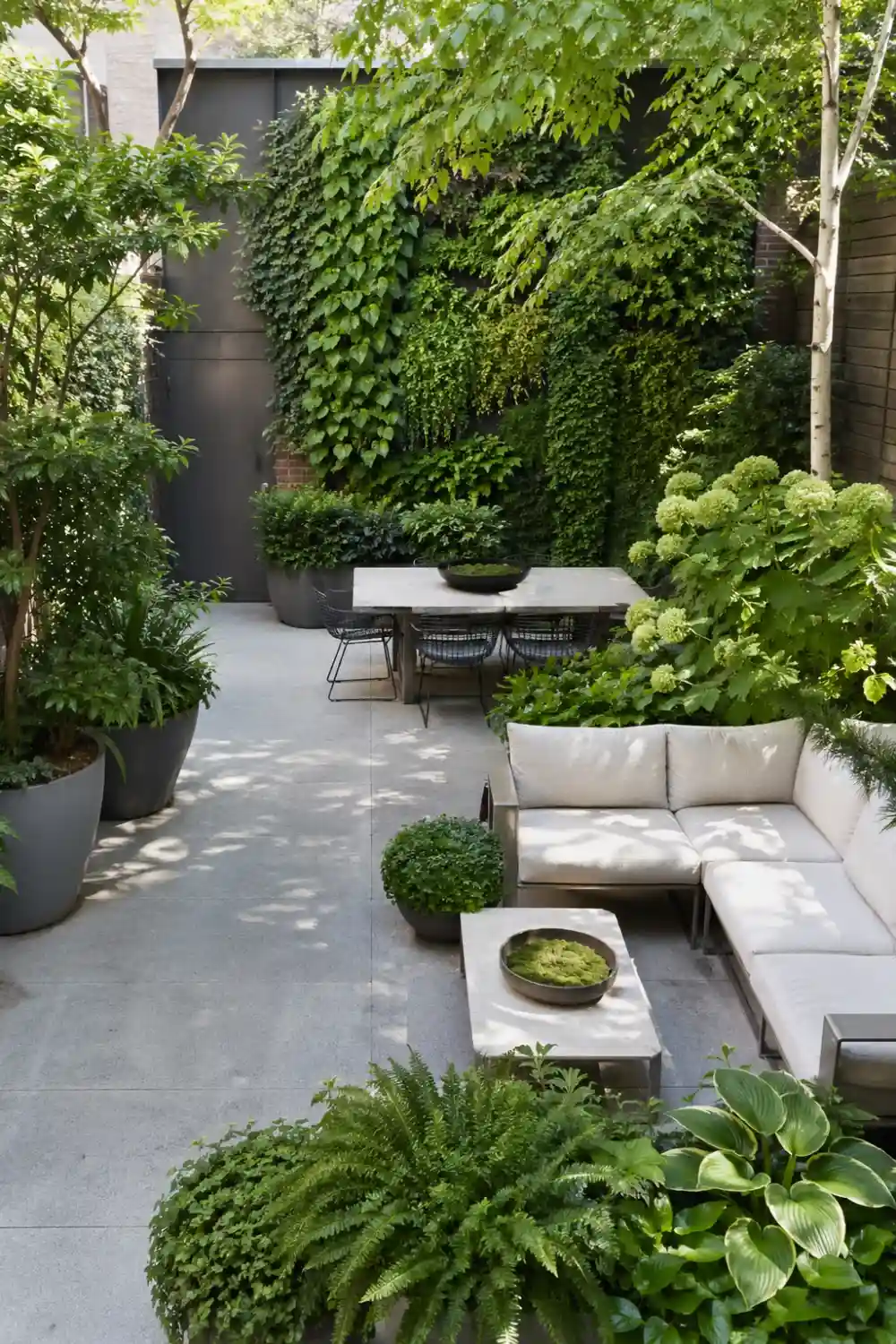 lush green patio with multiple plants, vertical garden wall, modern seating, concrete slab floor, layered greenery, outdoor garden retreat design, natural backyard atmosphere