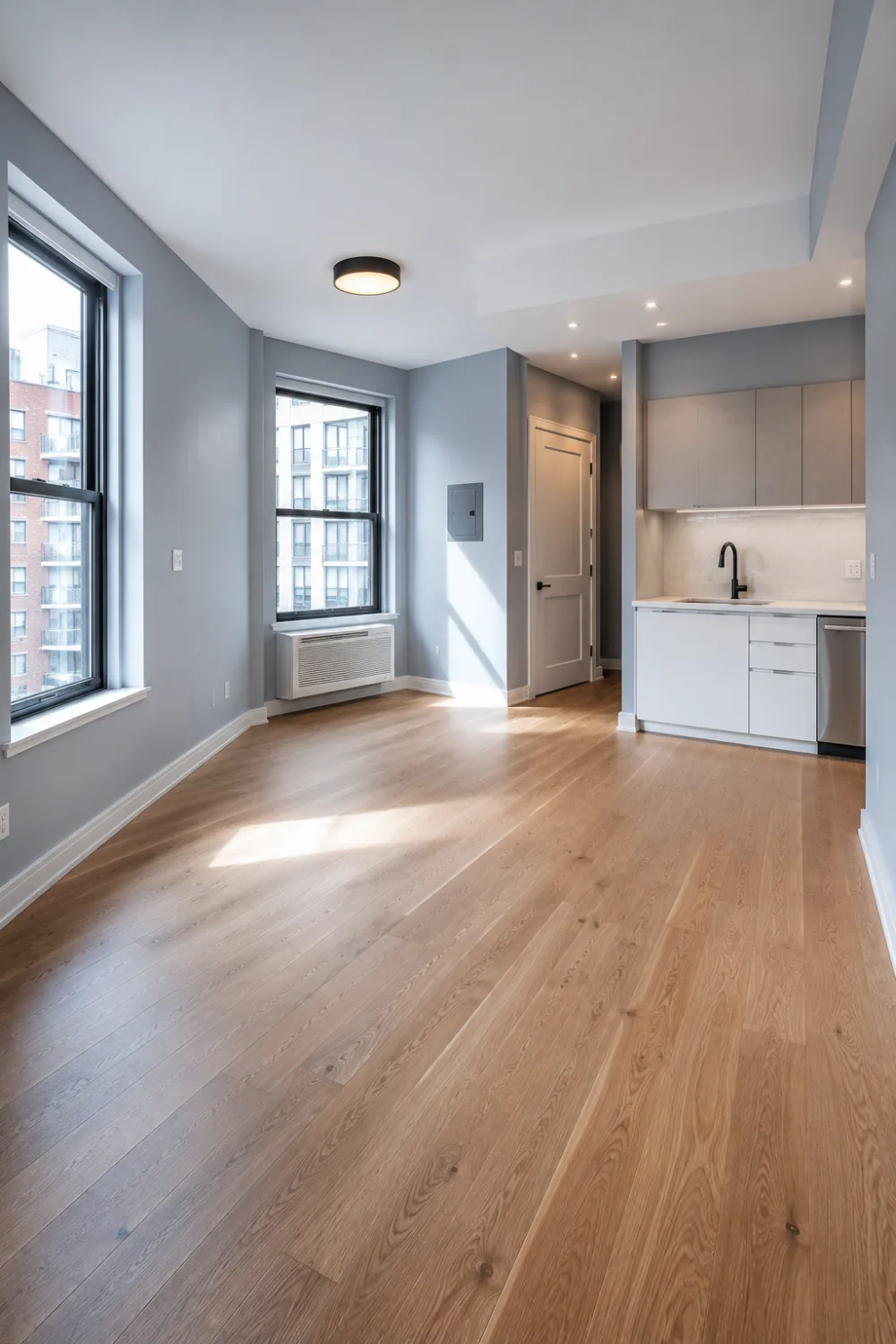 Frosted blue apartment interior with modern kitchen, large windows, light wood floors, and minimalist contemporary home design.