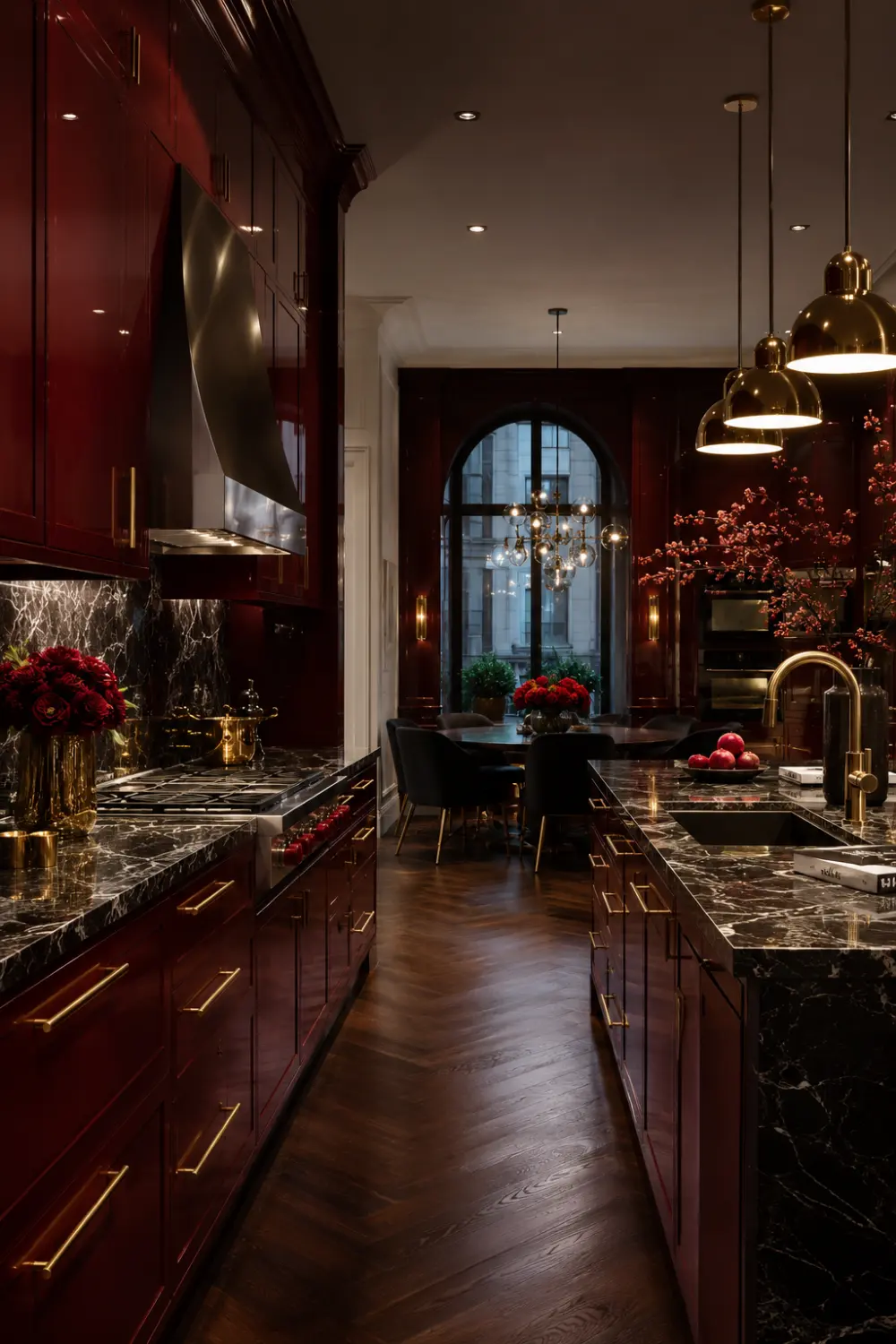 Bold cherry red kitchen cabinets with black marble countertops, gold accents, dramatic lighting, and luxury modern kitchen decor