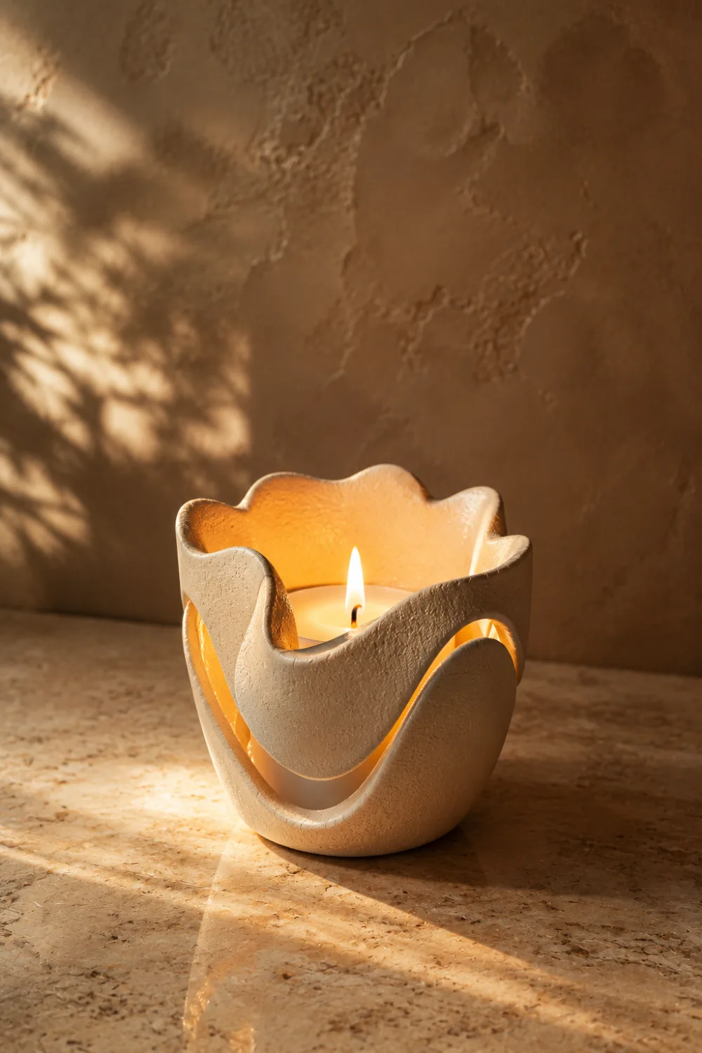 Sculptural handmade clay candle holder with glowing candlelight and organic ceramic design. Elegant pottery decor idea for coffee tables, dining rooms, cozy bedrooms, and modern home styling inspiration.