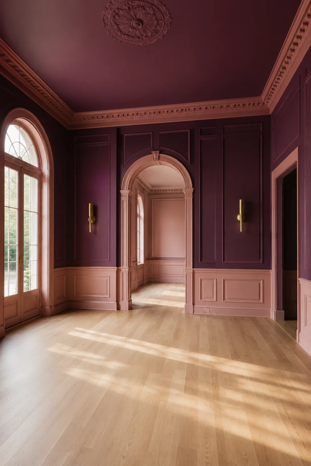 Grand entryway featuring jewel-toned plum walls, blush accents, arched architectural openings, gold wall sconces, natural sunlight, and luxury foyer design with elegant molding details.