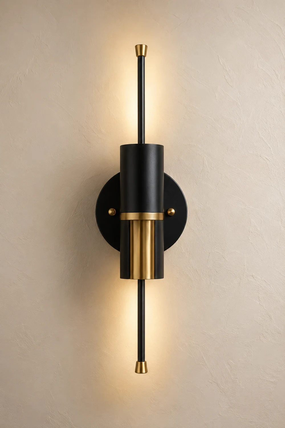 Black and gold wall sconce with a sleek cylindrical design, matte black finish, and brushed brass accents mounted on a textured wall, creating a bold luxury statement in a contemporary interior.