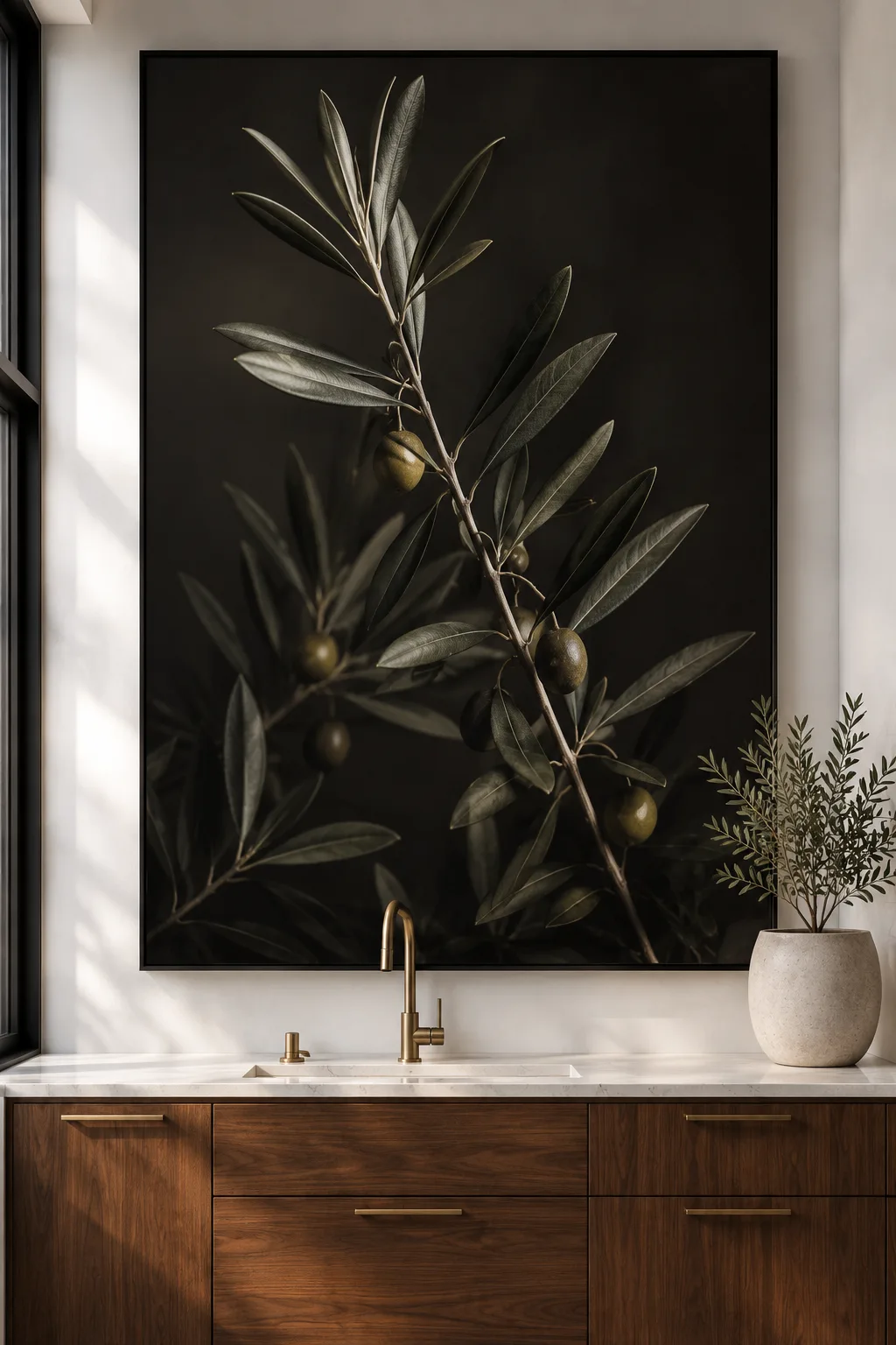 Large botanical olive branch wall art in a black gallery frame above a modern walnut kitchen cabinet with brass faucet, white countertops, neutral decor, and luxury contemporary kitchen styling for elegant wall decor inspiration.