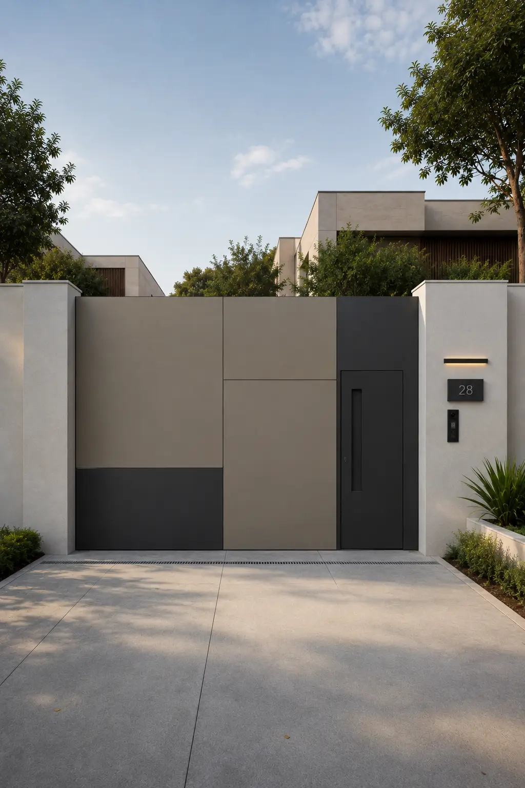 Modern two tone entrance gate featuring large warm greige and deep graphite geometric panels, an integrated dark pedestrian door, recessed black handle, clean asymmetrical panel divisions, white boundary walls, minimalist exterior lighting, modern house numbers, and subtle landscaping for a polished home entrance.