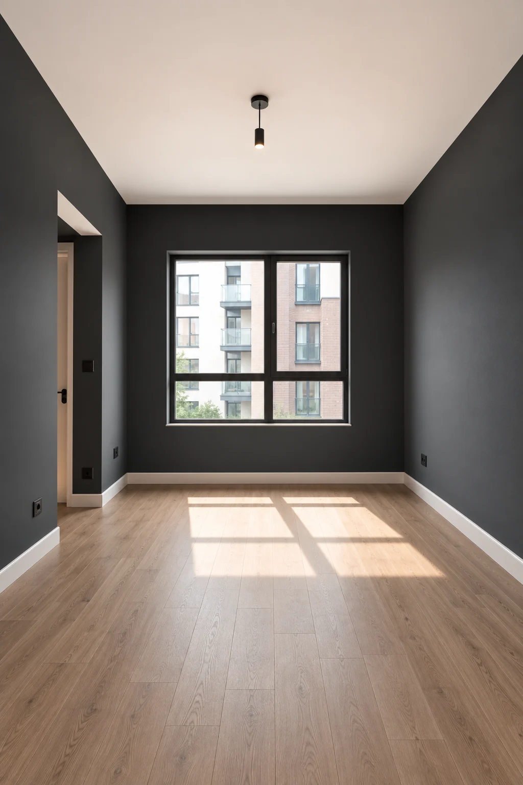 Empty contemporary bedroom featuring deep charcoal gray paint across all four walls, with a bright white ceiling, light natural wood flooring, large central window, simple architectural doorway, crisp white baseboards, realistic matte paint texture, natural daylight, and a sleek dramatic interior showcasing modern charcoal gray bedroom walls.
