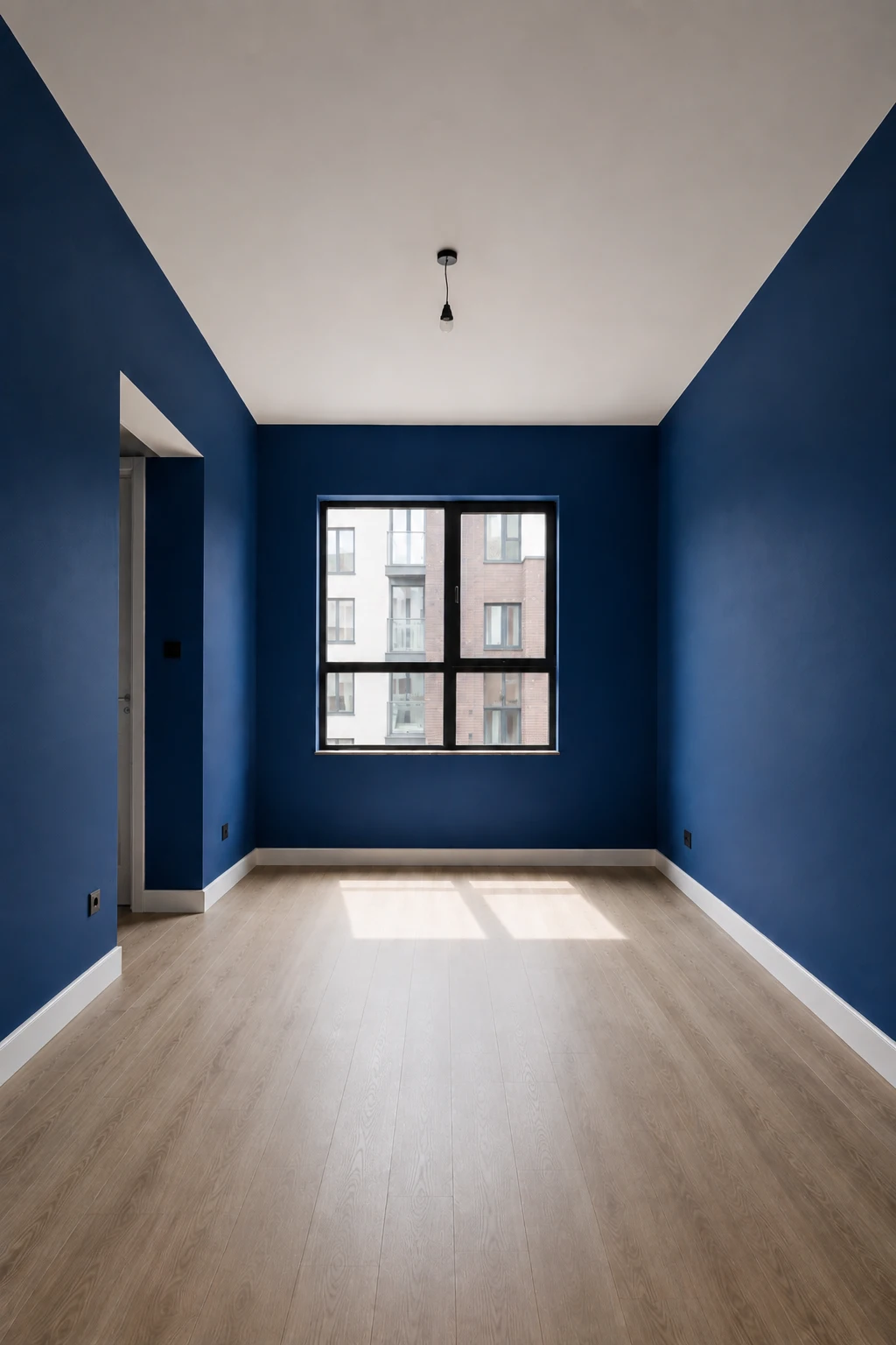 Empty contemporary bedroom with all four walls covered in rich deep navy blue paint, featuring a clean white ceiling, light natural wood flooring, large central window, architectural doorway, white baseboards, realistic matte wall texture, strong natural daylight, and a dramatic yet sophisticated interior showcasing deep navy blue bedroom paint.