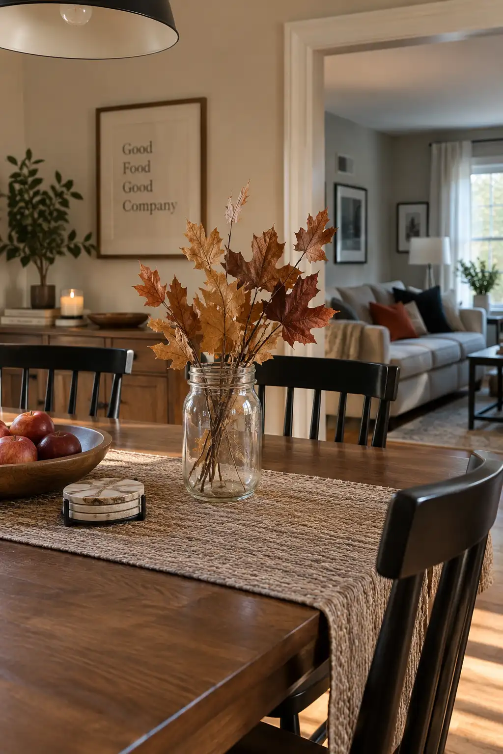 Realistic home interior with naturally dried autumn leaves arranged in a simple reused glass jar on a table, creating an inexpensive seasonal decoration.