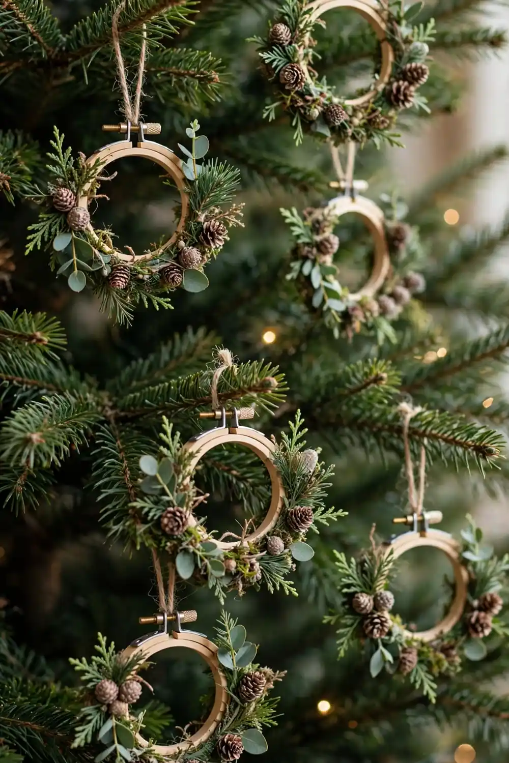Mini embroidery hoop wreath ornament with greenery, a charming diy christmas ornament idea