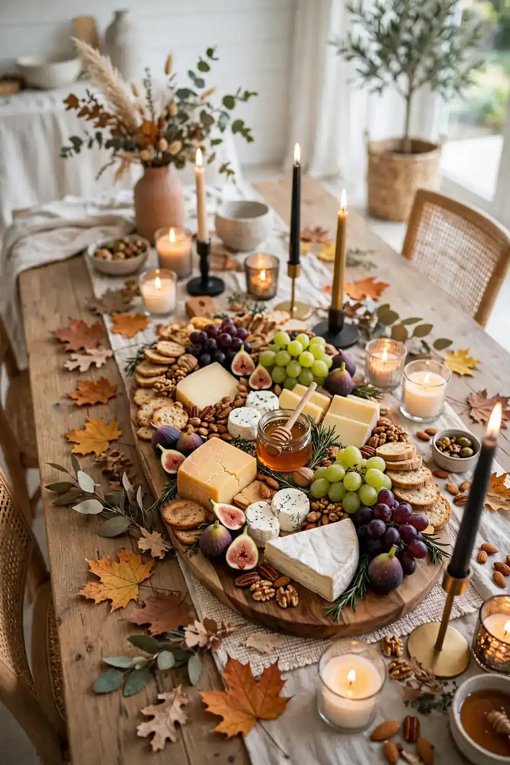 Friendsgiving table decor ideas with a grazing board centerpiece of cheese and fruit